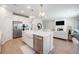Well-lit kitchen with stainless steel appliances and a central island, open to the living area at 7045 Stonecrop Ln, Johns Island, SC 29455