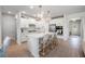 Beautiful white kitchen featuring an island with bar seating, stainless steel appliances, and stylish lighting at 7045 Stonecrop Ln, Johns Island, SC 29455