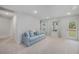 Cozy upstairs living room featuring a comfortable sofa and lots of natural light at 7045 Stonecrop Ln, Johns Island, SC 29455