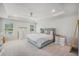 Bright main bedroom featuring tray ceiling, a ceiling fan, and two windows at 7045 Stonecrop Ln, Johns Island, SC 29455