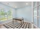 Bright home office featuring a window and a charming checkered rug under a wooden desk at 7045 Stonecrop Ln, Johns Island, SC 29455