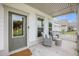 Cozy front porch featuring comfortable wicker chairs and a small table, creating an inviting outdoor space at 7045 Stonecrop Ln, Johns Island, SC 29455