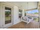 Inviting covered porch featuring a charming swing and wood flooring at 7045 Stonecrop Ln, Johns Island, SC 29455