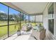 Screened-in porch with comfortable seating and a view of the expansive backyard at 7045 Stonecrop Ln, Johns Island, SC 29455