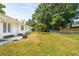 Large backyard featuring a well-maintained lawn, chain-link fence, and access from the house through double doors at 747 Brant Rd, Charleston, SC 29414