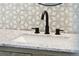 Bathroom vanity with granite countertop, matte black hardware and faucet, and decorative tile backsplash at 747 Brant Rd, Charleston, SC 29414