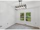 Bright dining room featuring an updated light fixture and natural light from the backyard view at 747 Brant Rd, Charleston, SC 29414