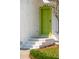 A close up view of the home's front door with white brick and a bright green door at 747 Brant Rd, Charleston, SC 29414