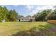 An exterior view showcases the home with a shed and expansive green lawn at 7986 Highway 162, Hollywood, SC 29449