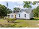 Exterior view of the home with a covered front porch and lush landscaping at 7986 Highway 162, Hollywood, SC 29449