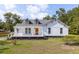 Charming home boasts a covered front porch, complemented by lush green grass and landscaping at 7986 Highway 162, Hollywood, SC 29449