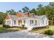 Charming two-story home with a large wrap-around front porch and landscaped yard at 7986 Highway 162, Hollywood, SC 29449