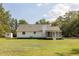 An exterior view showcases the home with a screened porch, shed and expansive green lawn at 7986 Highway 162, Hollywood, SC 29449