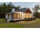 Well-lit screened-in porch with a backyard view of the home at dusk at 7986 Highway 162, Hollywood, SC 29449