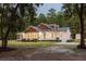 Beautiful two-story home with cedar shake and white siding, a porch, and a well-manicured lawn at dusk at 7986 Highway 162, Hollywood, SC 29449