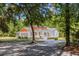 Charming two-story home with a large front porch and beautiful landscaping nestled among mature trees at 7986 Highway 162, Hollywood, SC 29449