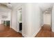 Hallway with hardwood floors leading to a bathroom and kitchen at 7986 Highway 162, Hollywood, SC 29449