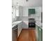 Beautiful kitchen features a white backsplash, stainless steel appliances, and a green kitchen island with a marble countertop at 7986 Highway 162, Hollywood, SC 29449