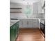 Charming kitchen with a white backsplash, floating shelves, and elegant fixtures at 7986 Highway 162, Hollywood, SC 29449
