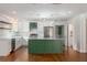 Bright kitchen with white cabinets, stainless appliances, a marble countertop island and hardwood floors at 7986 Highway 162, Hollywood, SC 29449