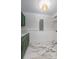Bright laundry room features striking marble floors, sleek green cabinets, and modern lighting at 7986 Highway 162, Hollywood, SC 29449