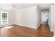 Well-lit room with hardwood floors, white trim, and large windows offering ample natural light at 7986 Highway 162, Hollywood, SC 29449