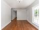 Bright living room featuring hardwood floors, white trim, natural light, and open access to other rooms at 7986 Highway 162, Hollywood, SC 29449