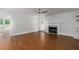 Spacious living room with hardwood floors and fireplace, illuminated by natural light at 7986 Highway 162, Hollywood, SC 29449