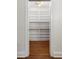 Well-organized pantry with ample shelving, a tiled backsplash, and hardwood floors at 7986 Highway 162, Hollywood, SC 29449