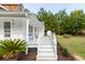 Inviting front porch with a white railing and palm tree views at 7986 Highway 162, Hollywood, SC 29449