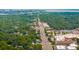 An aerial view showing a city street lined with trees and buildings with water and bridges in the distance at 8 Tovey Rd, Charleston, SC 29407