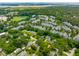 Aerial view showcasing a low-density neighborhood, surrounded by mature trees and with proximity to the coastline at 8 Tovey Rd, Charleston, SC 29407