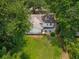 Aerial view of a white home with a manicured backyard and patio seating at 8 Tovey Rd, Charleston, SC 29407