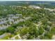Aerial view showcases a neighborhood filled with tree-covered homes at 8 Tovey Rd, Charleston, SC 29407