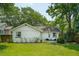 Well-maintained backyard features green lawn and white home with seating area at 8 Tovey Rd, Charleston, SC 29407