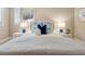 Bright bedroom features a large bed with blue and white accents, and white nightstands with blue lamps at 8 Tovey Rd, Charleston, SC 29407