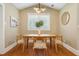 Bright dining room with modern light fixture, stylish decor and wood floors at 8 Tovey Rd, Charleston, SC 29407