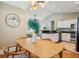 Open concept dining area offering natural light, a wooden table, and seamless flow to the kitchen at 8 Tovey Rd, Charleston, SC 29407