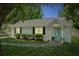 Charming single-story home with a light blue front door, white exterior, and neatly trimmed landscaping at 8 Tovey Rd, Charleston, SC 29407