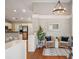 Bright foyer featuring hardwood floors, a modern light fixture, and an open layout leading to the living area at 8 Tovey Rd, Charleston, SC 29407