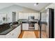 Bright kitchen boasts stainless steel appliances, granite countertops, and white cabinetry at 8 Tovey Rd, Charleston, SC 29407
