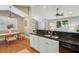 Modern kitchen features granite counters, stainless appliances, and seamless connection to dining and living spaces at 8 Tovey Rd, Charleston, SC 29407