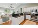 Open concept kitchen with stainless appliances, granite counters, and seamless flow to the living area at 8 Tovey Rd, Charleston, SC 29407