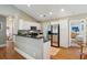 Well-equipped kitchen with white cabinets, black granite countertops, and stainless steel appliances at 8 Tovey Rd, Charleston, SC 29407