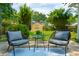 Back patio features a seating area with comfortable chairs, a table, and a blue rug at 8 Tovey Rd, Charleston, SC 29407