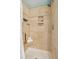 Neutral tiled walk-in shower features a built-in niche and a rain shower head for a spa-like experience at 8 Tovey Rd, Charleston, SC 29407