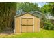 Storage shed with double doors and surrounded by a lush green yard at 8 Tovey Rd, Charleston, SC 29407