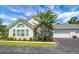 Charming home featuring a stone facade, large windows, well-maintained landscaping, and an attached two-car garage at 8800 Dorchester Rd # 2004, North Charleston, SC 29420