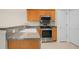 Well-lit kitchen with granite countertops, stainless steel appliances, wood cabinets, and a double sink at 8800 Dorchester Rd # 2004, North Charleston, SC 29420