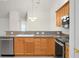 Kitchen featuring wood cabinets, granite countertops, stainless steel appliances, and an ornate chandelier at 8800 Dorchester Rd # 2004, North Charleston, SC 29420